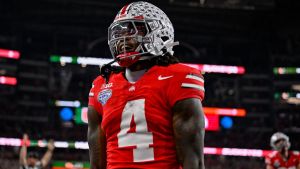 Dec 31, 2025; Arlington, TX, USA; Ohio State Buckeyes wide receiver Jeremiah Smith (4) celebrates after he runs for a touchdown during the 2025 Cotton Bowl and quarterfinal game of the College Football Playoff at AT&T Stadium. Mandatory Credit: Jerome Miron-Imagn Images