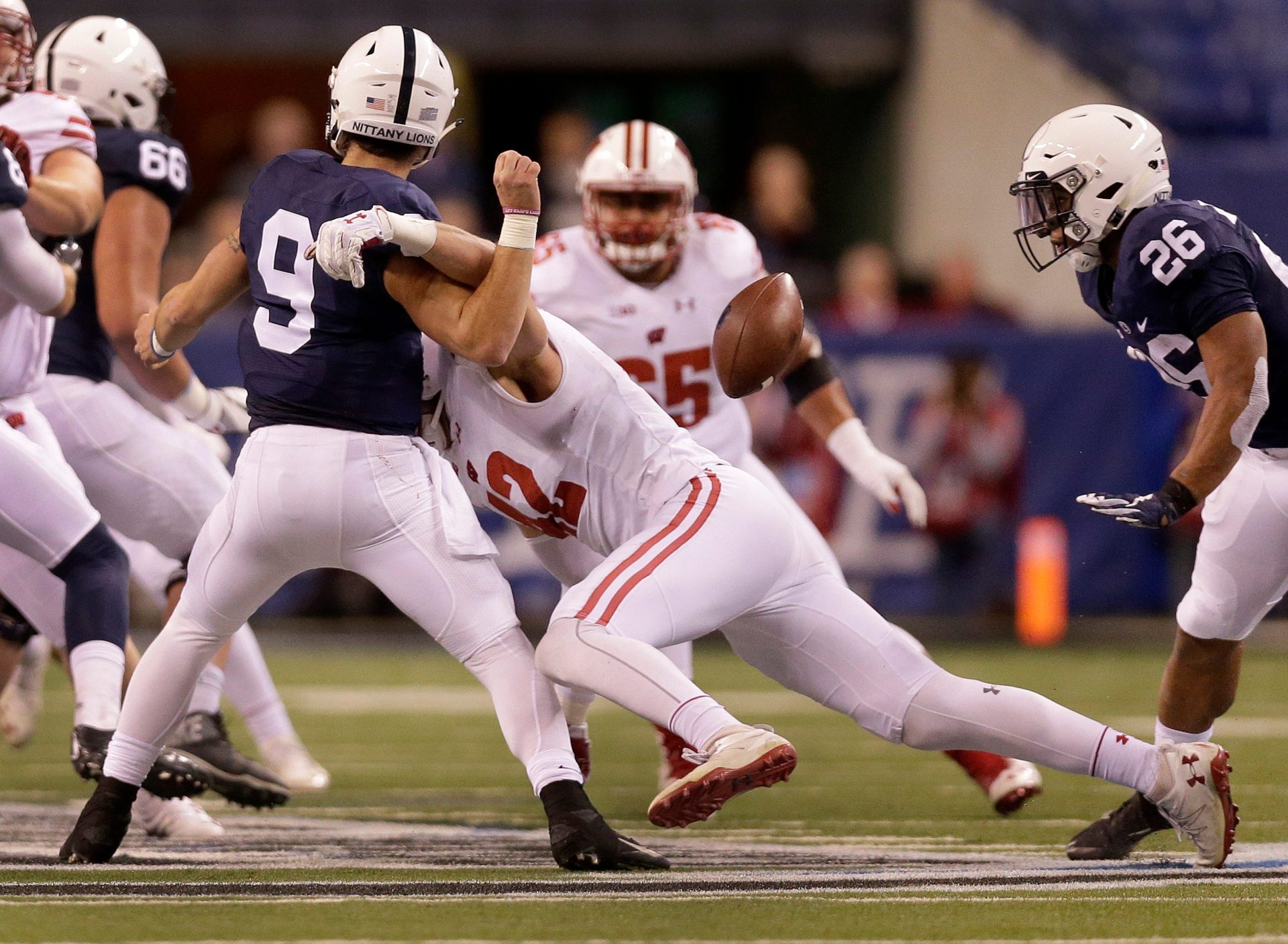 Wisconsin Badgers linebacker T.J. Watt (42) hits Penn State Nittany Lions quarterback Trace McSorley (9) forcing a fumble recovered by the Badgers in the second quarter of the Big Ten football championship game Saturday, December 3, 2016, at Lucas Oil Stadium.