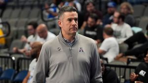 American Conference Commissioner Tim Pernetti walks next to the court before the first round American Conference Tournament game between Memphis and Tulane in Birmingham, Ala, on March 11, 2026.