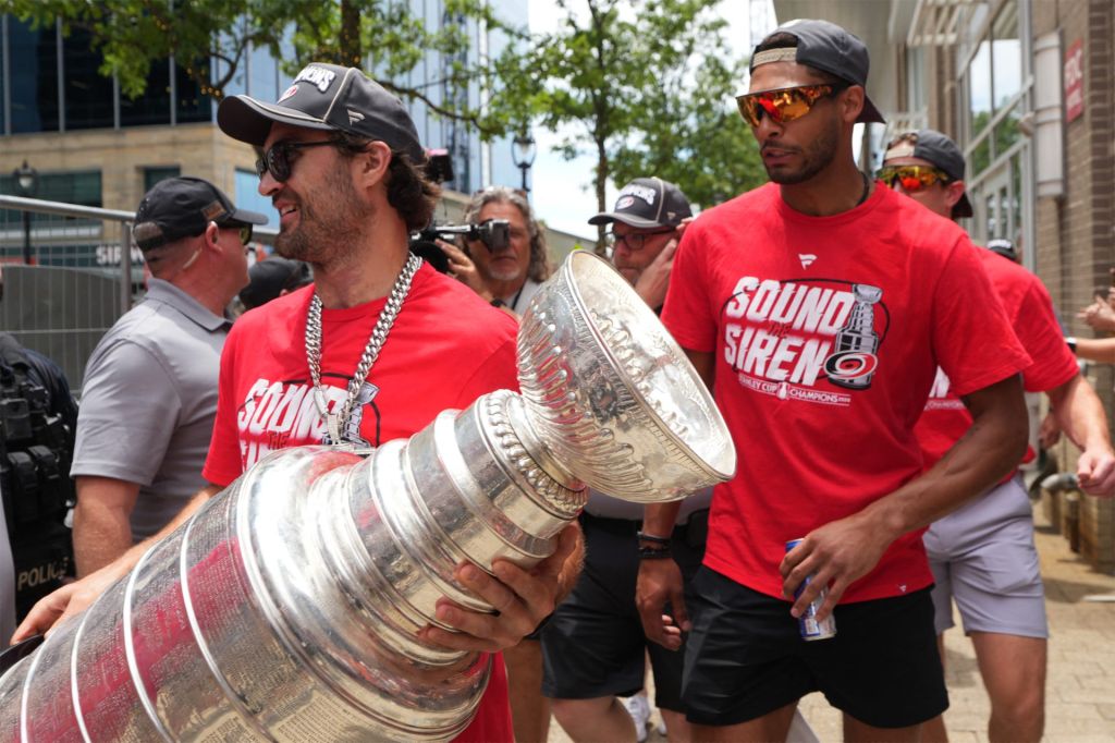Jun 20, 2026; Raleigh, North Carolina, USA; Carolina Hurricanes left wing William Carrier (28) and defenseman K'andre Miller (19) walk out with the Stanley Cup trophy during the Stanley Cup championship parade and rally at Raleigh.