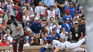 Jul 5, 2026; Chicago, Illinois, USA; Chicago Cubs second baseman Nico Hoerner (2) slides into score against the St. Louis Cardinals during the sixth inning at Wrigley Field.