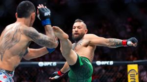 Jul 11, 2026; Las Vegas, Nevada, USA; Conor McGregor (right) attempts a flying kick at the start of his fight against Max Holloway during UFC 329 at T-Mobile Arena. Mandatory Credit: Mark J. Rebilas-Imagn Images TPX IMAGES OF THE DAY
