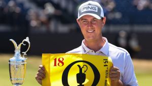 Jul 13, 2026; Southport, England; Joe Dean poses with an eighteenth hole flag alongside the Claret Jug as he wins the Last Qualifier for The Open Championship golf tournament at Royal Birkdale. Mandatory Credit: Bill Streicher-Imagn Images