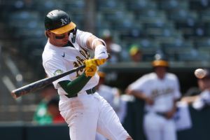Jul 19, 2026; West Sacramento, California, USA; Athletics shortstop Jacob Wilson (5) hits an RBI single during the ninth inning against the Washington Nationals at Sutter Health Park.