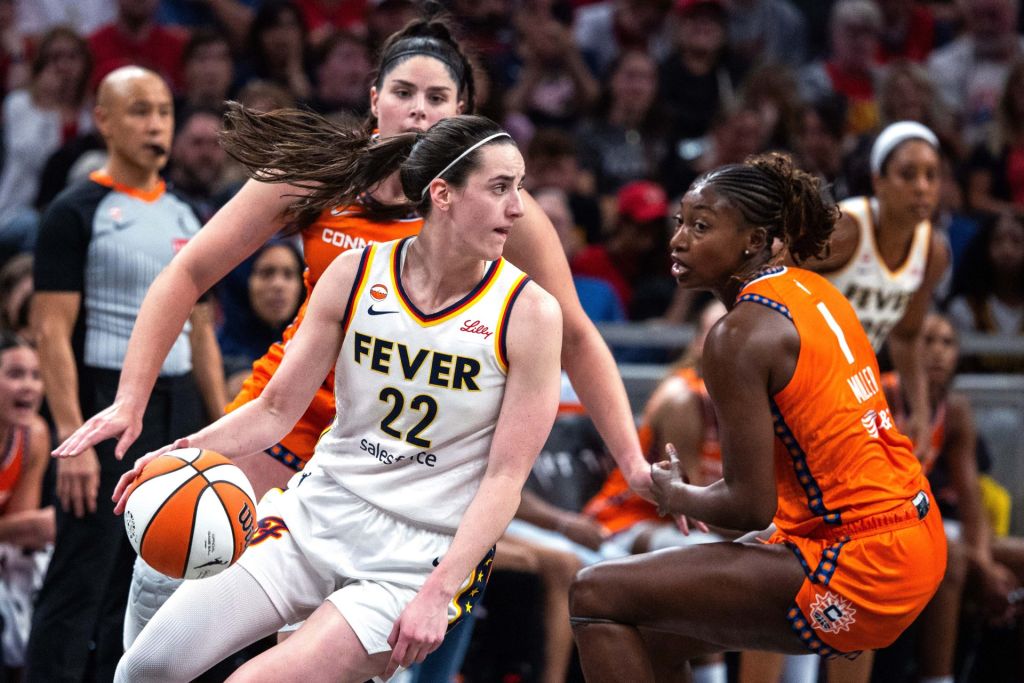 Jul 22, 2026; Indianapolis, Indiana, USA; Indiana Fever guard Caitlin Clark (22) dribbles the ball while Connecticut Sun forward Diamond Miller (1) defends in the second half at Gainbridge Fieldhouse.