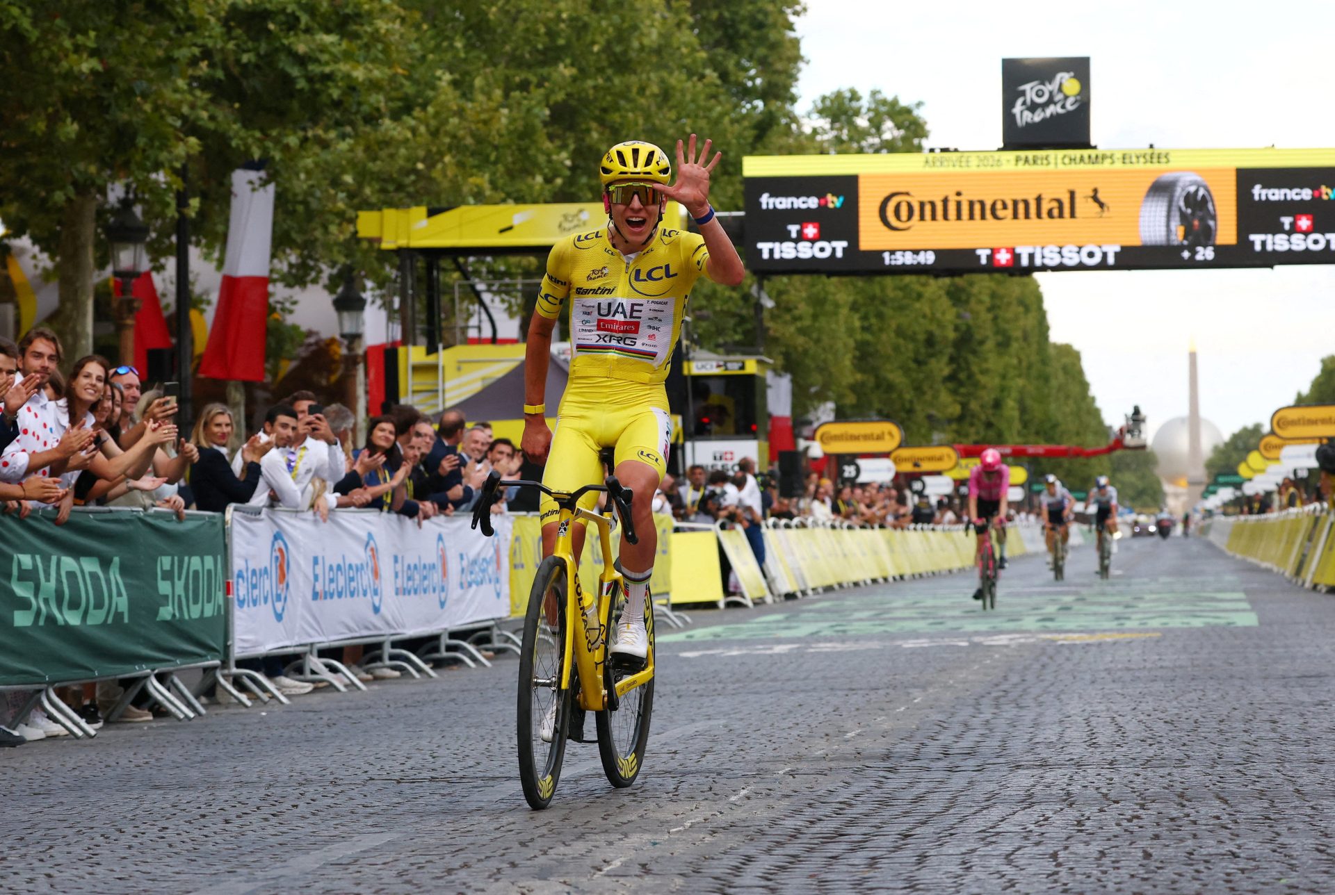 Cycling - Tour de France - Stage 21 - Paris, France - July 26, 2026 UAE Team Emirates XRG's Tadej Pogacar wearing the yellow jersey celebrates after completing stage 21