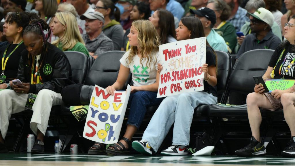 Jul 28, 2026; Seattle, Washington, USA; Fan hold a Indiana Fever guard Sophie Cunningham (8) (not pictured) sign during the first half between the Seattle Storm and the Indiana Fever at Climate Pledge Arena. Mandatory Credit: Steven Bisig-Imagn Images