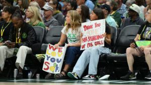 Jul 28, 2026; Seattle, Washington, USA; Fan hold a Indiana Fever guard Sophie Cunningham (8) (not pictured) sign during the first half between the Seattle Storm and the Indiana Fever at Climate Pledge Arena. Mandatory Credit: Steven Bisig-Imagn Images