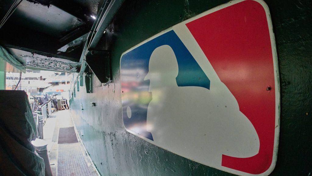 Aug 24, 2024; Oakland, California, USA; The major league baseball logo is seen on signage near the player's entrance to the field at Oakland-Alameda County Coliseum before the game between the Oakland Athletics and the Milwaukee Brewers. Mandatory Credit: Robert Edwards-USA TODAY Sports
