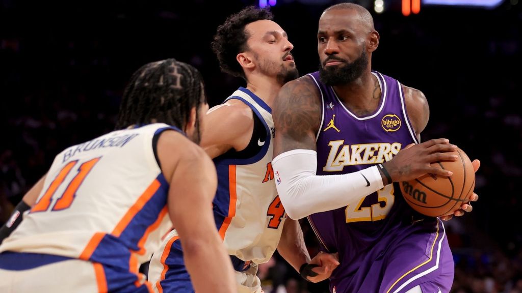 Feb 1, 2026; New York, New York, USA; Los Angeles Lakers forward LeBron James (23) drives to the basket against New York Knicks guards Jalen Brunson (11) and Landry Shamet (44) during the third quarter at Madison Square Garden. Mandatory Credit: Brad Penner-Imagn Images