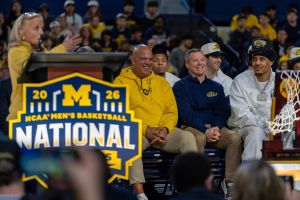 Michigan athletic director Warde Manuel, left, sits and laughs alongside head coach Dusty May and Yaxel Lendeborg during a celebration honoring the team’s NCAA men’s basketball national championship at Crisler Center in Ann Arbor on Saturday, April 11, 2026.