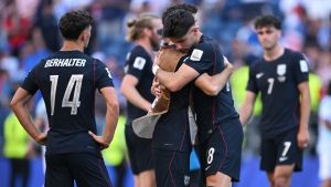 July 6, 2026; Seattle, Washington, U.S.; Christian Pulisic and Max Arfsten of the U.S. look dejected as they embrace after the match following their elimination from the World Cup. Mandatory Credit: Troy Wayrynen-Imagn Images