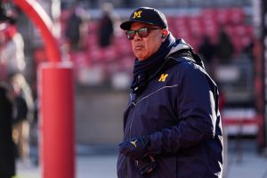 Michigan athletic director Warde Manuel watches warmups from the field before school's game against Ohio State at Ohio Stadium in Columbus.
