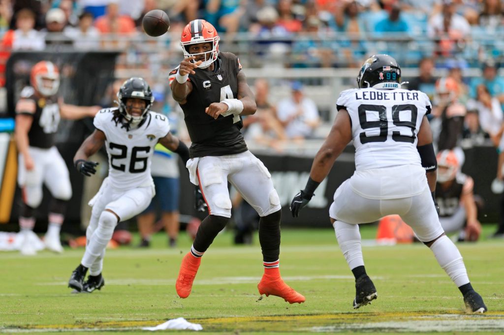 Cleveland Browns quarterback Deshaun Watson (4) throws the ball as Jacksonville Jaguars safety Antonio Johnson (26) and defensive tackle Jeremiah Ledbetter (99) look on during the third quarter of an NFL football matchup Sunday, Sept. 15, 2024 at EverBank Stadium in Jacksonville, Fla. The Browns defeated the Jaguars 18-13. 