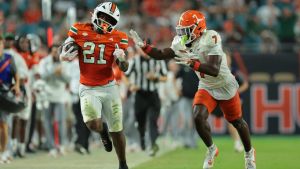 Sep 10, 2026; Miami Gardens, Florida, USA; Miami Hurricanes running back Javian Mallory (21) carries the ball while defended by Florida A&M Rattlers defensive back Andre Powell Jr. (7) in the third quarter at Hard Rock Stadium. Mandatory Credit: Sam Navarro-Imagn Images